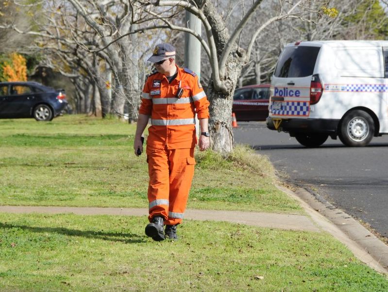 A State Emergency Service volunteer search suburban streets for clues to an alleged murder in Wilsonton Heights. A State Emergency Service volunteer search suburban streets for clues to an alleged murder in Wilsonton Heights.