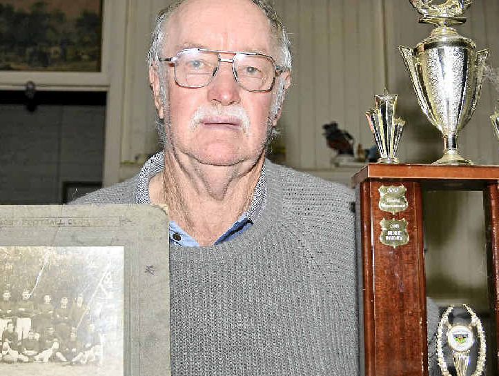 Blackbutt Timbertowners president Barry Richardson displays a photo of the original Blackbutt rugby league team of 1913 and the Ian Blackbutt Timbertowners president Barry Richardson displays a photo of the original Blackbutt rugby league team of 1913 and the Ian