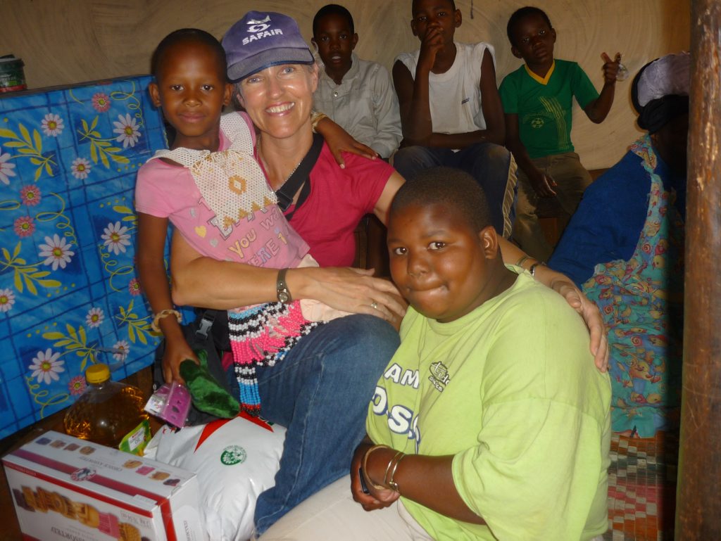 Gillian Gardiner in South Africa with her World Vision sponsor child Awandilie and members of the village. Contributed Gillian Gardiner in South Africa with her World Vision sponsor child Awandilie and members of the village. Contributed
