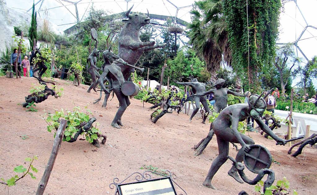 Imaginative metal sculptures of wine god Dionysus, depicted as a bull, and dancing maids are featured in a planting of grapes. Imaginative metal sculptures of wine god Dionysus, depicted as a bull, and dancing maids are featured in a planting of grapes.