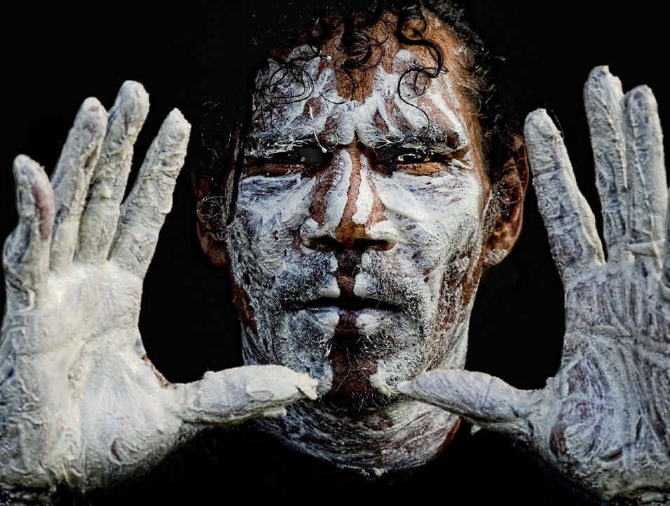 CULTURAL DANCE: Lewis Walker shows off some of the paint he and the dancers wear before a performance at the NAIDOC Week celebration at Ngaru Village Hall. Photo: Adam Hourigan