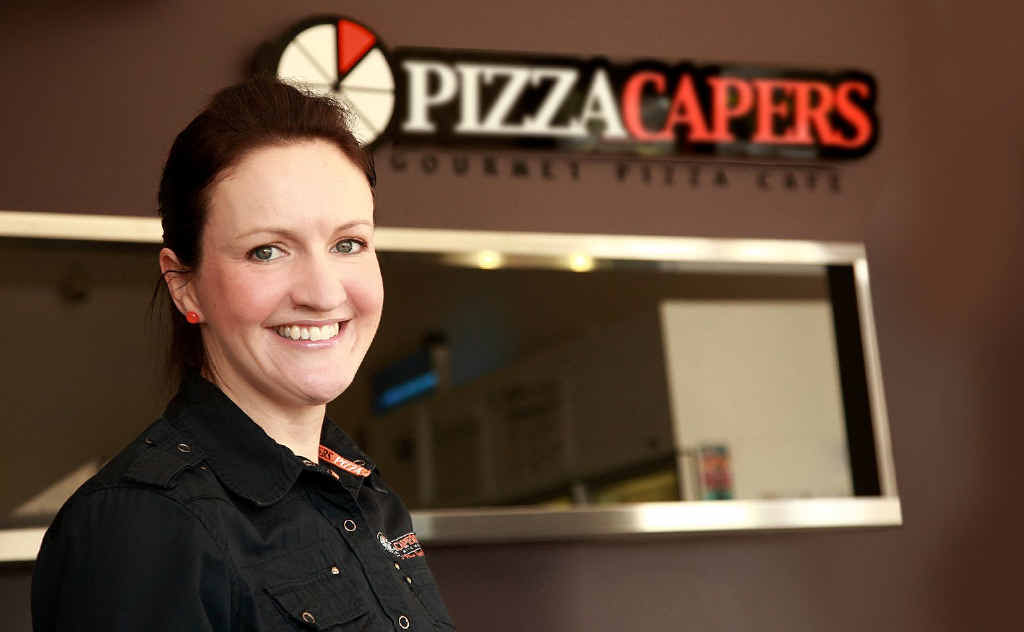 AT YOUR SERVICE: Pizza Capers franchisee Katherine McNamara in one of the two stores she operates in Ipswich with her husband Jason. AT YOUR SERVICE: Pizza Capers franchisee Katherine McNamara in one of the two stores she operates in Ipswich with her husband Jason.