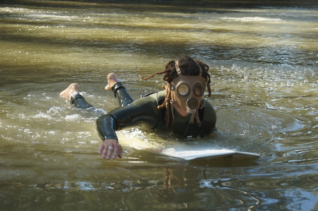 PROTESTING: Musician Ash Grunwald paddles into the bubbling Condamine River to raise awareness about CSG mining. PROTESTING: Musician Ash Grunwald paddles into the bubbling Condamine River to raise awareness about CSG mining.