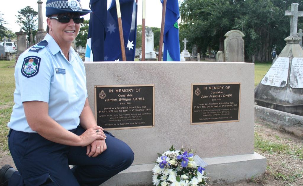 PAYING HOMAGE: Childers Senior Constable Donna Gilliland, who was stationed at Blackwater previously, kneels beside the graves of the first policers officers murdered in the Rockhampton region: Constables Patrick Cahill and John Power. Snr Const Gilliland was behind the push to have a memorial stone in place for the serving officers. Photo: Austin King / The Morning Bulletin PAYING HOMAGE: Childers Senior Constable Donna Gilliland, who was stationed at Blackwater previously, kneels beside the graves of the first policers officers murdered in the Rockhampton region: Constables Patrick Cahill and John Power. Snr Const Gilliland was behind the push to have a memorial stone in place for the serving officers. Photo: Austin King / The Morning Bulletin