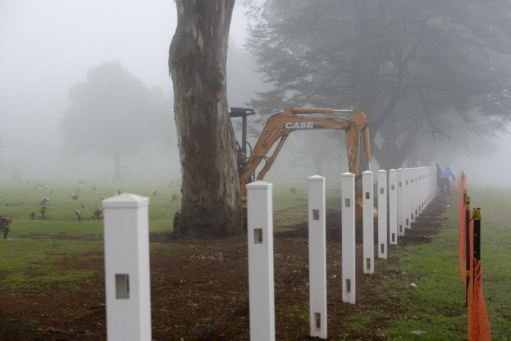 A concrete mowing edge is being placed under the newly erected Drayton and Toowoomba Cemetery fence, Thursday, July 18, 2013. Photo Kevin Farmer / The Chronicle
