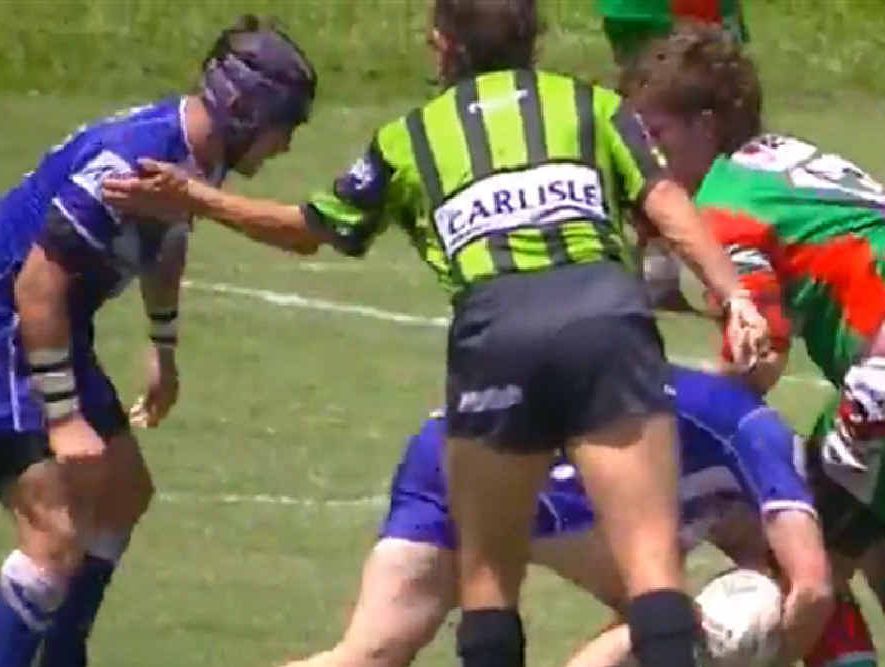 A referee in the U18 Moranbah versus Sarina match appears to tap a player on the helmet. A referee in the U18 Moranbah versus Sarina match appears to tap a player on the helmet.