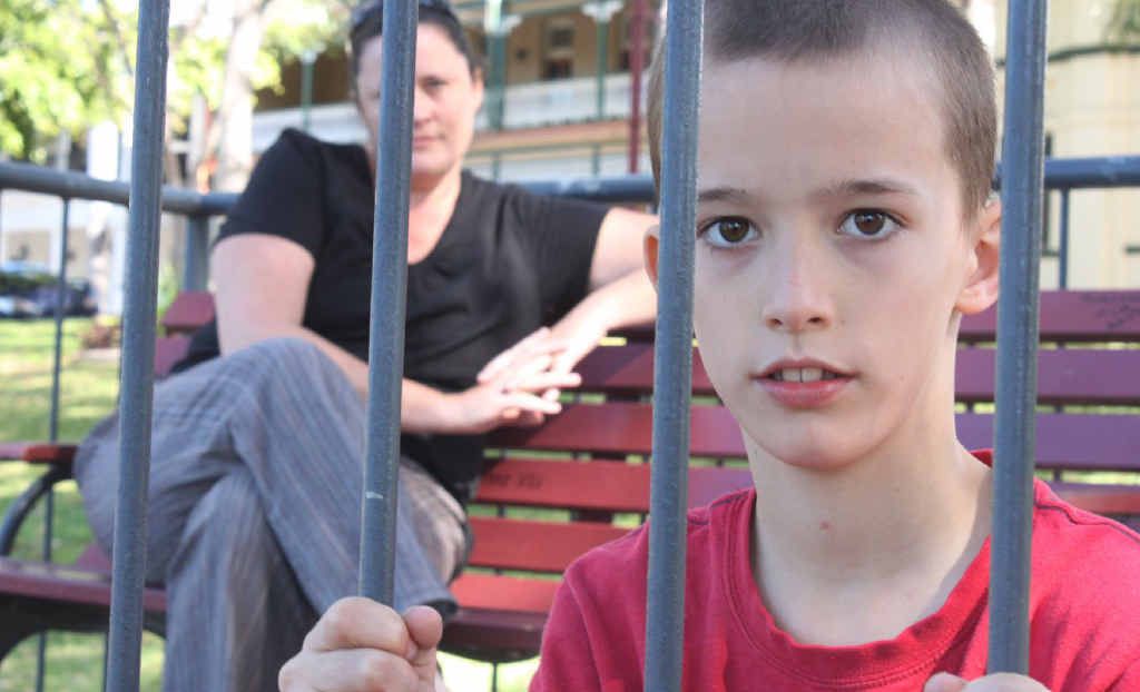 Gracemere boy Jeremiah Murray grasps at the bars pleading for justice to be served. His mother Rachel Murray sits in the background Gracemere boy Jeremiah Murray grasps at the bars pleading for justice to be served. His mother Rachel Murray sits in the background