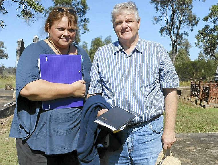 Gympie Family History Society’s Di Woodstock who organised Sunday’s tour of local cemeteries with John Rayner who travelled up from Murrumba Downs for the day. John’s great-grandparents are buried in the grave behind him and other relatives in the graves in the background.