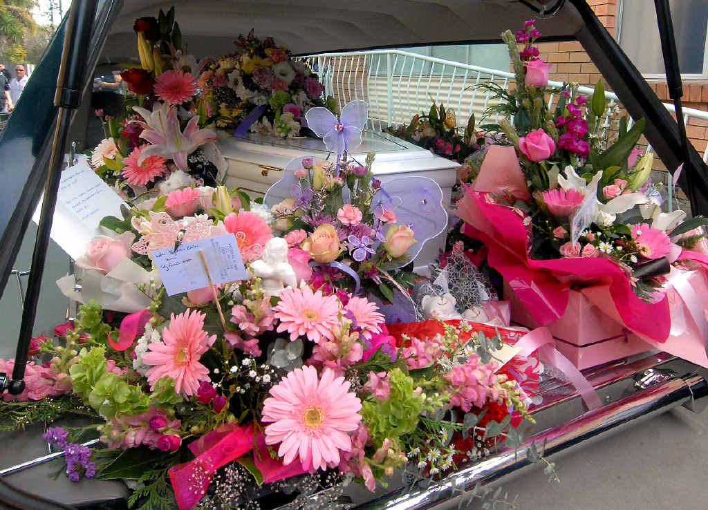 ANGEL SISTERS: Alysha, 9, and Emilee, 7, Sauer were buried in the same casket, arm in arm. Among them were bright flowers and butterflies during the funeral service, held in Mackay yesterday. ANGEL SISTERS: Alysha, 9, and Emilee, 7, Sauer were buried in the same casket, arm in arm. Among them were bright flowers and butterflies during the funeral service, held in Mackay yesterday.