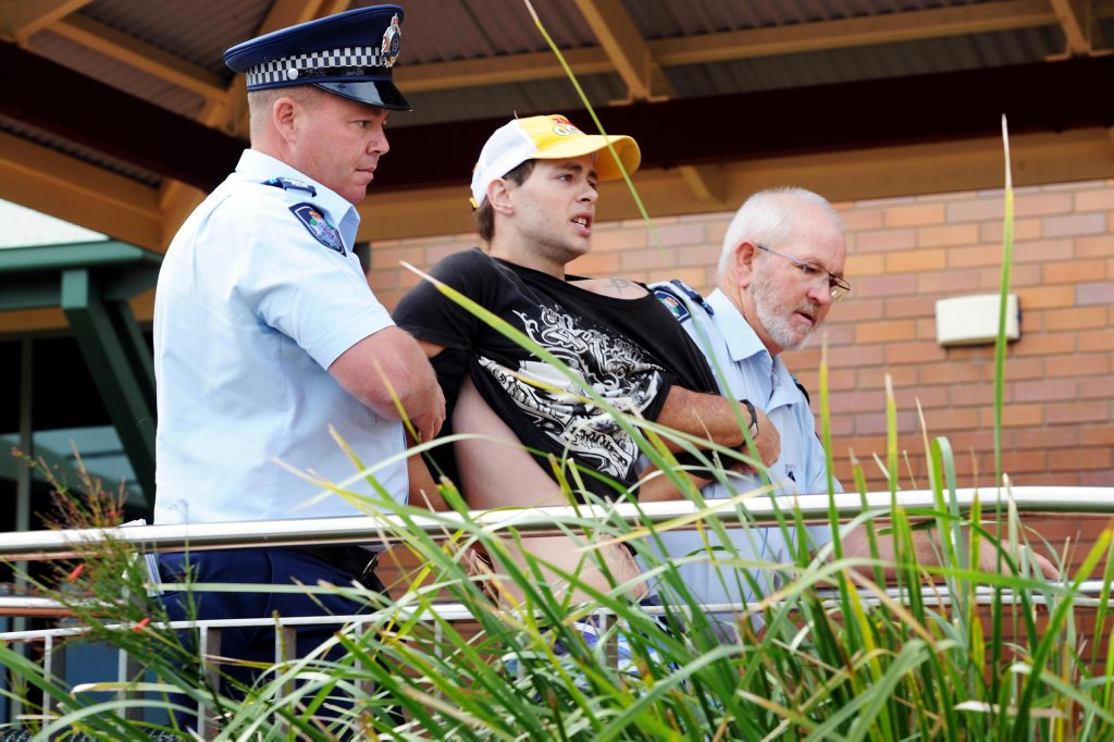 The 19-year-old brother of Kym David Baxter-Sayers is led back to the Hervey Bay police station after screaming abuse outside the courthouse. The 19-year-old brother of Kym David Baxter-Sayers is led back to the Hervey Bay police station after screaming abuse outside the courthouse.