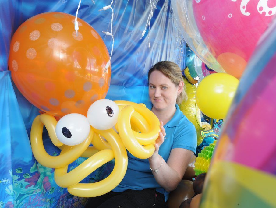 Stacey Taplin from A Stylish Celebration decorating the front window of the business on Torquay Rd in an ocean theme to get in the spirit of the month-long Whale Festival celebrations.