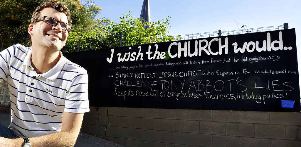 WISHFUL THINKING: Pastor Scott Muir from Central Church Ipswich next to the interactive community chalkboard on Limestone Street. WISHFUL THINKING: Pastor Scott Muir from Central Church Ipswich next to the interactive community chalkboard on Limestone Street.
