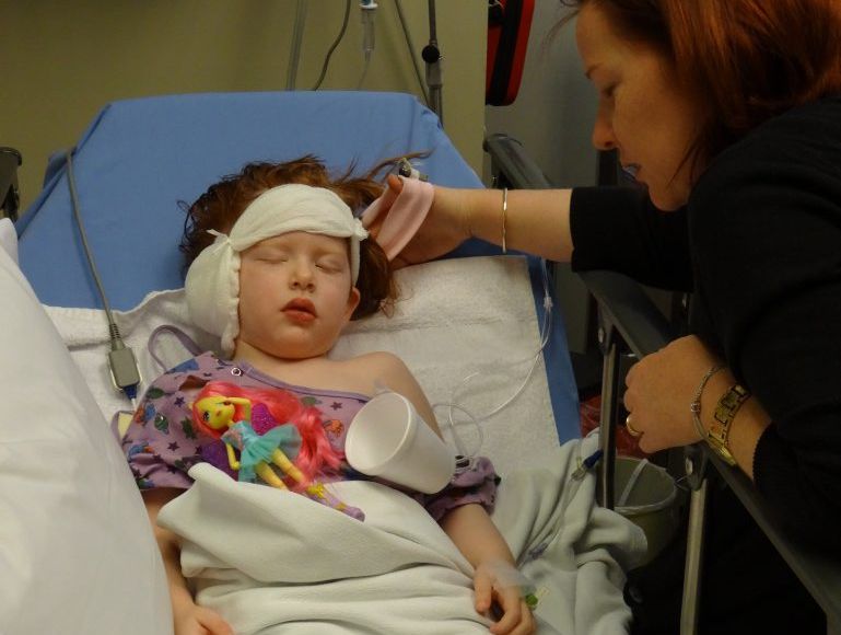 Little Alana Reid rests after the 10-hour surgery to correct her hearing. Little Alana Reid rests after the 10-hour surgery to correct her hearing.