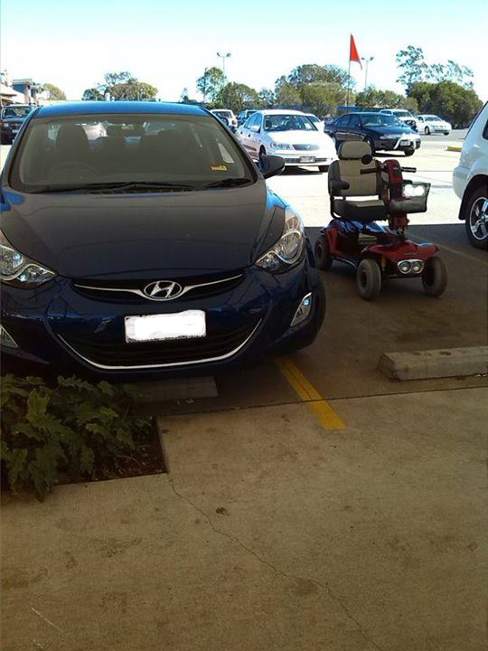 A mobility scooter takes up a parking space at Coles Wilsonton while the driver of the vehicle in the next parking space struggles to stay within the yellow lines. A mobility scooter takes up a parking space at Coles Wilsonton while the driver of the vehicle in the next parking space struggles to stay within the yellow lines.