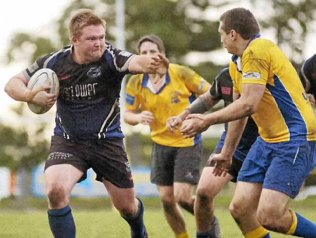 JUST TRY IT: Ballina’s Adam Thomas fends off an SCU foe on his way to the try line during Saturday’s clash at Quays Reserve. JUST TRY IT: Ballina’s Adam Thomas fends off an SCU foe on his way to the try line during Saturday’s clash at Quays Reserve.