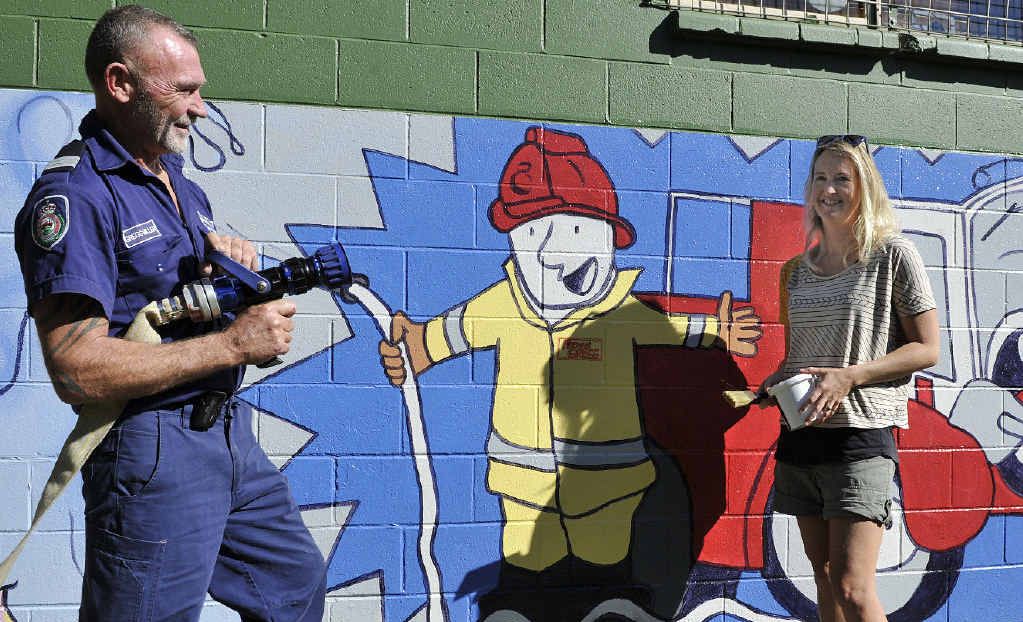 SAFER FOR KIDS: Captain Gregg Miller and artist Narani Henson with the mural. SAFER FOR KIDS: Captain Gregg Miller and artist Narani Henson with the mural.