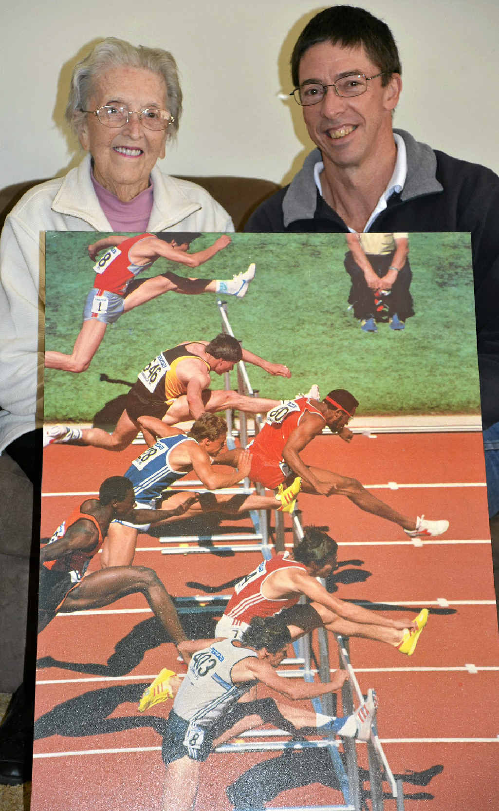 Daily News Sports Star of the Century Don Wright with his mother Lillian and an athletics action poster showing him in action (646) in Canberra.