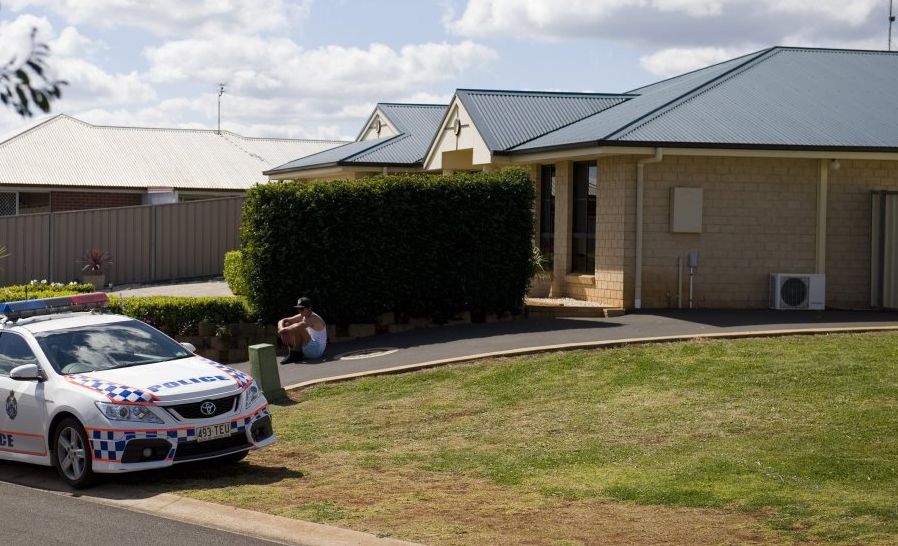 A police officer waits in front of the Harristown home where four teenagers were injured in a bonfire explosion. A police officer waits in front of the Harristown home where four teenagers were injured in a bonfire explosion.