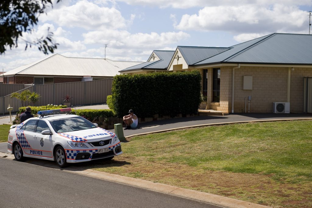 A police officer waits in front of the Harristown home where four teenagers were injured in a bonfire explosion. A police officer waits in front of the Harristown home where four teenagers were injured in a bonfire explosion.