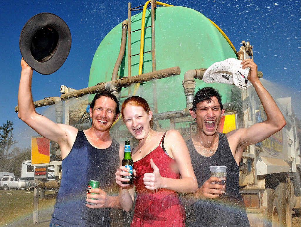 The only way these hard core Muster-goers could cool down in sweltering conditions was to jump under the back of the Campbells water truck. Pictured (from left) is Dave Matthews from Geelong, Neily Bambrick and Yanni Angelo Maltabes, both from Gladstone. The only way these hard core Muster-goers could cool down in sweltering conditions was to jump under the back of the Campbells water truck. Pictured (from left) is Dave Matthews from Geelong, Neily Bambrick and Yanni Angelo Maltabes, both from Gladstone.