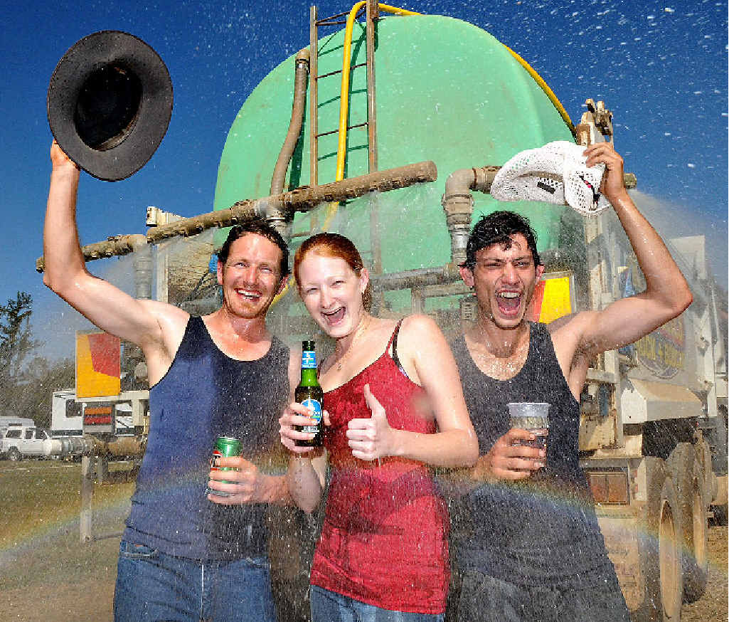 The only way these hard core Muster-goers could cool down in sweltering conditions was to jump under the back of the Campbells water truck. Pictured (from left) is Dave Matthews from Geelong, Neily Bambrick and Yanni Angelo Maltabes, both from Gladstone. The only way these hard core Muster-goers could cool down in sweltering conditions was to jump under the back of the Campbells water truck. Pictured (from left) is Dave Matthews from Geelong, Neily Bambrick and Yanni Angelo Maltabes, both from Gladstone.