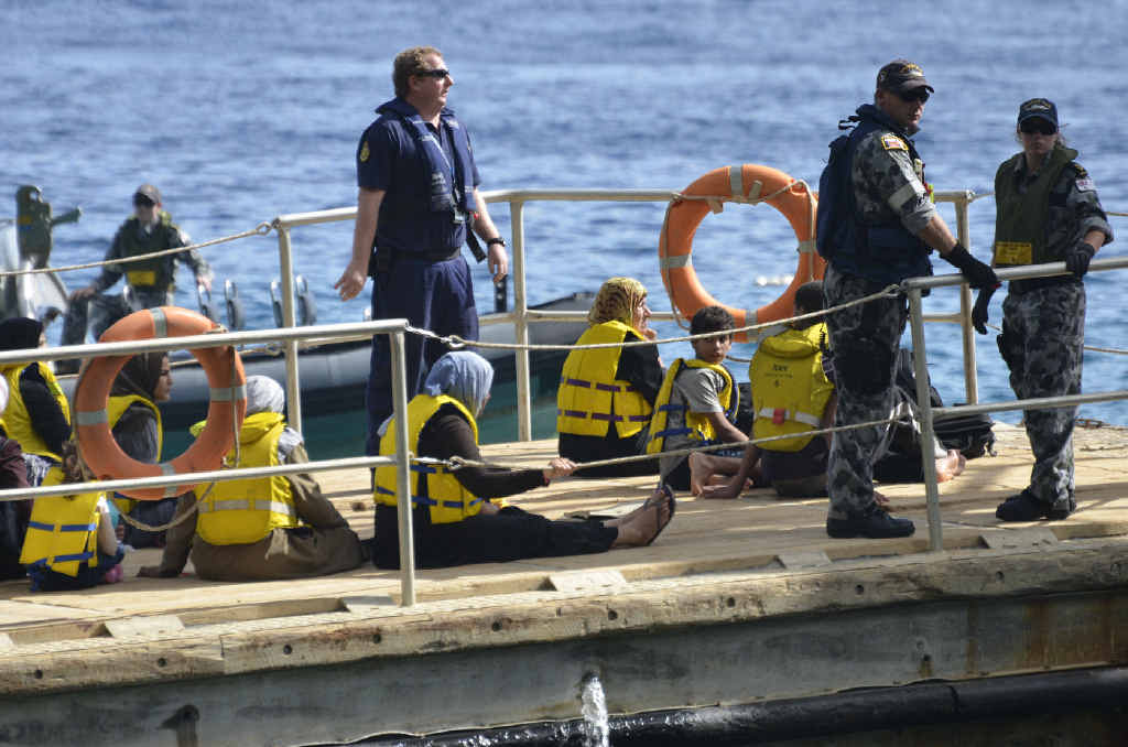 UNKNOWN FUTURE: Asylum seekers are transported to Christmas Island in 2012 after their boat issued a distress signal. UNKNOWN FUTURE: Asylum seekers are transported to Christmas Island in 2012 after their boat issued a distress signal.