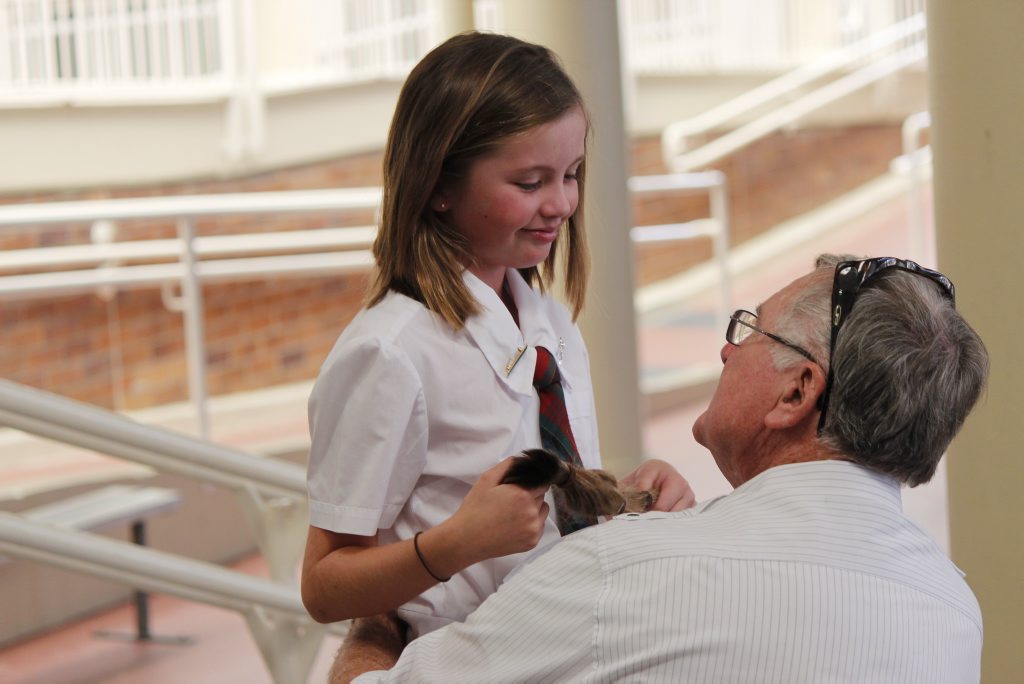 Grade 4 student Imogen Parry with her grandfather Richard Parry after chopping off her hair for cancer.