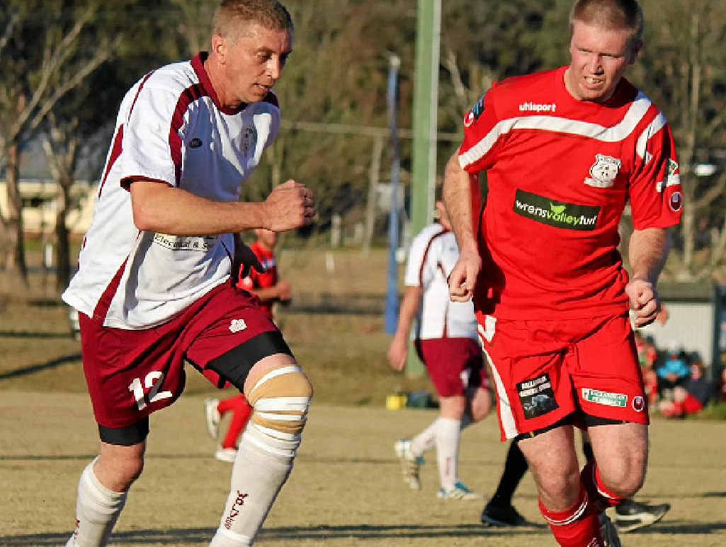 EYES ON THE BALL: Warwick Wolves player Stan Bain and Ballandean player Ashley Fleming in finals action. EYES ON THE BALL: Warwick Wolves player Stan Bain and Ballandean player Ashley Fleming in finals action.