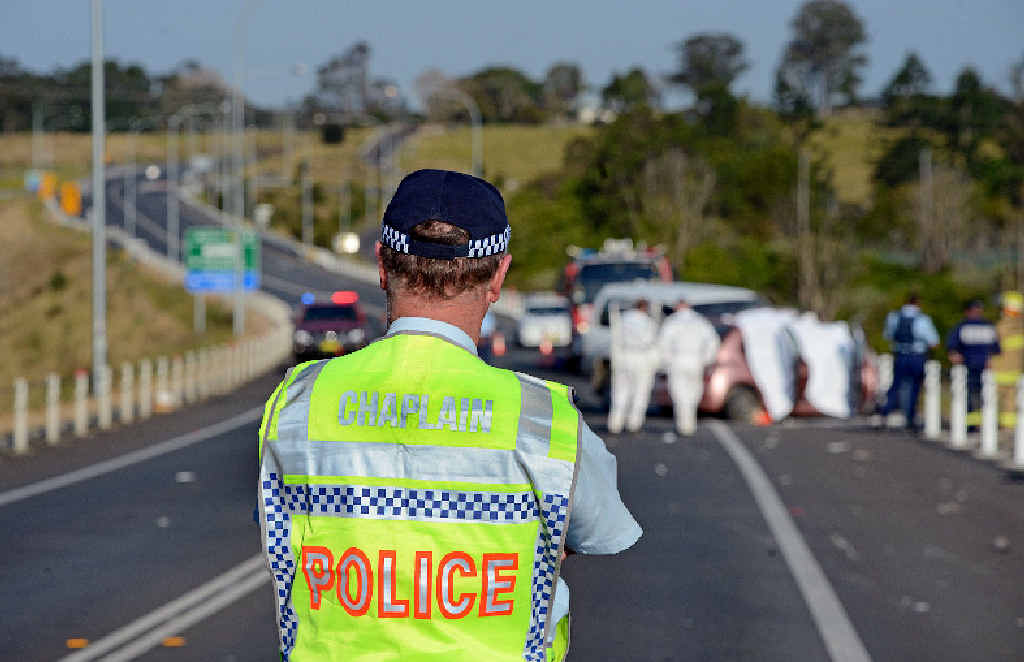 A police chaplain surveys the scene of the crash on the Bruxner Hwy, Wollongbar. A police chaplain surveys the scene of the crash on the Bruxner Hwy, Wollongbar.