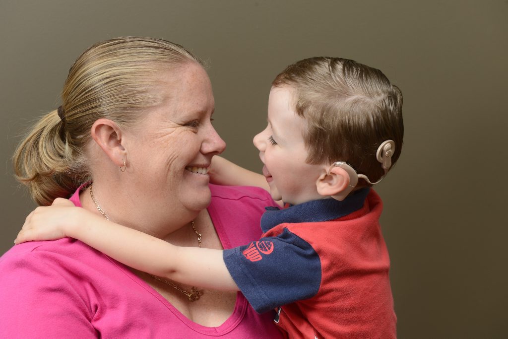Kristy Kelly with son Riley, 3 with his cochlear implant. Photo Adam Hourigan / The Daily Examiner Kristy Kelly with son Riley, 3 with his cochlear implant. Photo Adam Hourigan / The Daily Examiner