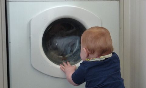 Child fascinated with the washing machine. Child fascinated with the washing machine.