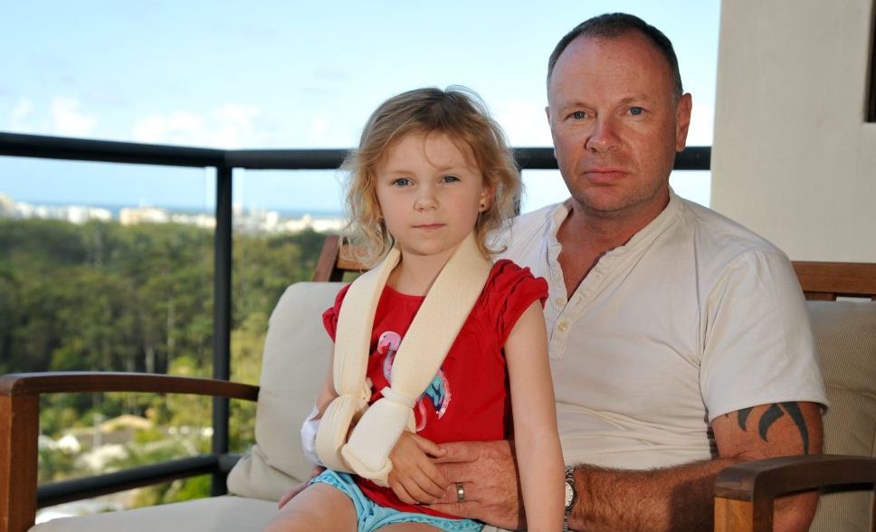 Chelsea Fletcher, 5, with dad Howard, of Buderim, was hit by a cyclist at Mooloolaba and suffered a broken collar bone, multiple abrasions, a cut head, cut knees, cut elbows, cut ankle, tyre marks on her back and bruising. Photo: Iain Curry / Sunshine Coast Daily Chelsea Fletcher, 5, with dad Howard, of Buderim, was hit by a cyclist at Mooloolaba and suffered a broken collar bone, multiple abrasions, a cut head, cut knees, cut elbows, cut ankle, tyre marks on her back and bruising. Photo: Iain Curry / Sunshine Coast Daily