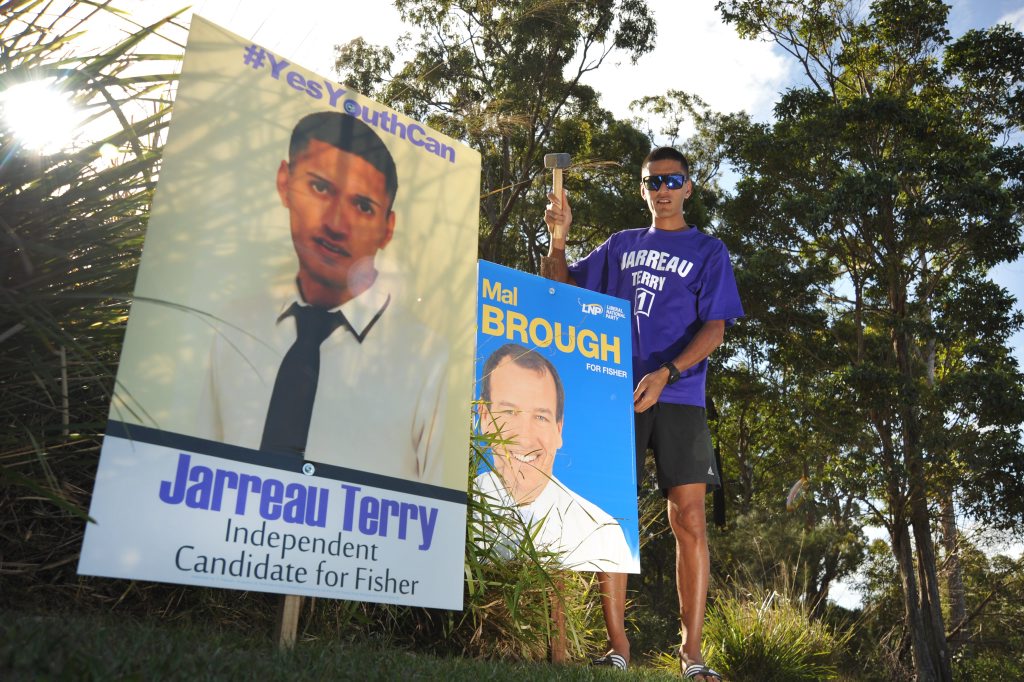 Jarreau Terry has been angry that his signs have been pulled out of the ground around Caloundra. he removed Mal Brough's sign in protest, but is seen hammering it back in to place after reconsidering the move. Photo: Iain Curry / Sunshine Coast Daily Jarreau Terry has been angry that his signs have been pulled out of the ground around Caloundra. he removed Mal Brough's sign in protest, but is seen hammering it back in to place after reconsidering the move. Photo: Iain Curry / Sunshine Coast Daily
