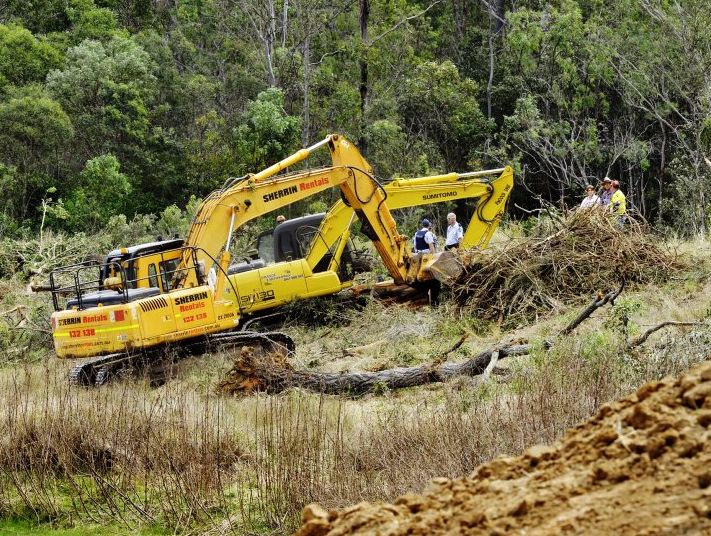 RESCUE: Emergency services at the scene of an accident in Grandchester in which a tree fell on the excavator driver, breaking his leg. RESCUE: Emergency services at the scene of an accident in Grandchester in which a tree fell on the excavator driver, breaking his leg.