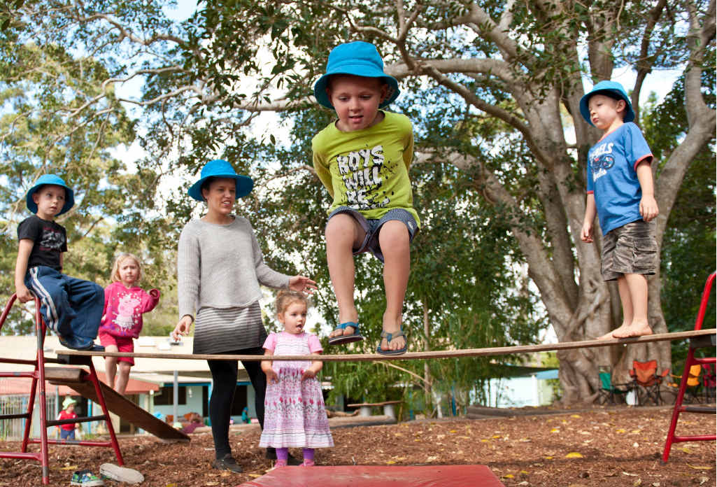 PLAYTIME: Childcare worker Arna Stevens supervising outdoor play time at Gamumbi. The children are hoping for new equipment from funds raised this Saturday. Photo: Rob Wright