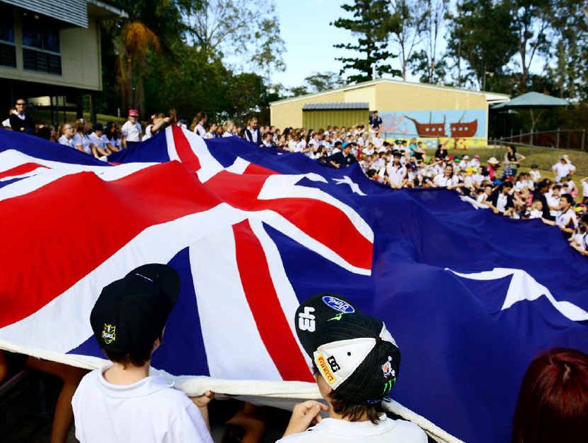 THAT’S A FLAG: Ipswich Central State School students unveil the Australian flag to mark Flag Day.