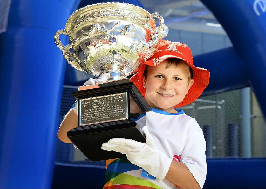 LITTLE KID, BIG TROPHY: Seven-year-old Kaiden Wendt from Ipswich Grammar School with the Norman Brookes Challenge Cup, the trophy awarded to the mens winner of the Australian Open. LITTLE KID, BIG TROPHY: Seven-year-old Kaiden Wendt from Ipswich Grammar School with the Norman Brookes Challenge Cup, the trophy awarded to the mens winner of the Australian Open.