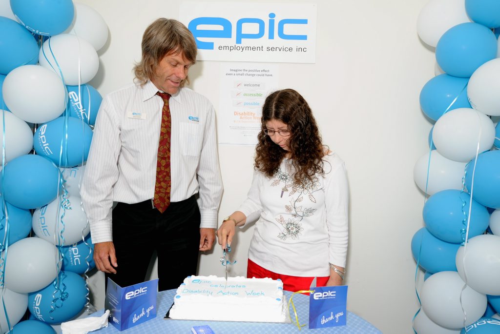Celebrating successes during Disability Action Week, EPIC's David Law and client Helen Pelling cut the celebratory cake during a morning tea in the Maryborough office. Photo: Robyne Cuerel / Fraser Coast Chronicle