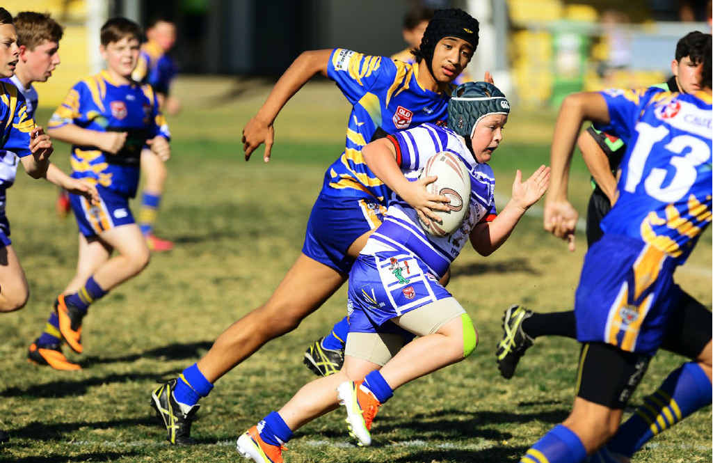 EXCITING FOOTY: A Brothers player tries to overun a Norths chaser during last weekend’s under-13 major preliminary final. Norths won 34-12. Right: Retiring Ipswich Junior Rugby League chairman Dave Nugent. EXCITING FOOTY: A Brothers player tries to overun a Norths chaser during last weekend’s under-13 major preliminary final. Norths won 34-12. Right: Retiring Ipswich Junior Rugby League chairman Dave Nugent.
