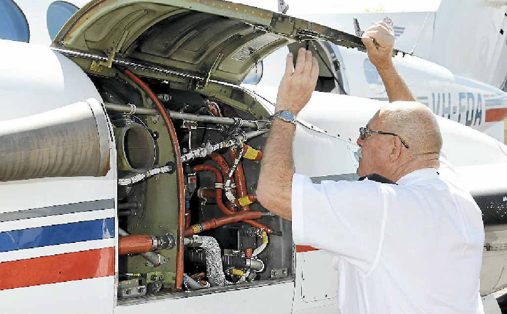RFDS pilot Graham Vonhoff checks his Beechcraft engine for the last time. RFDS pilot Graham Vonhoff checks his Beechcraft engine for the last time.