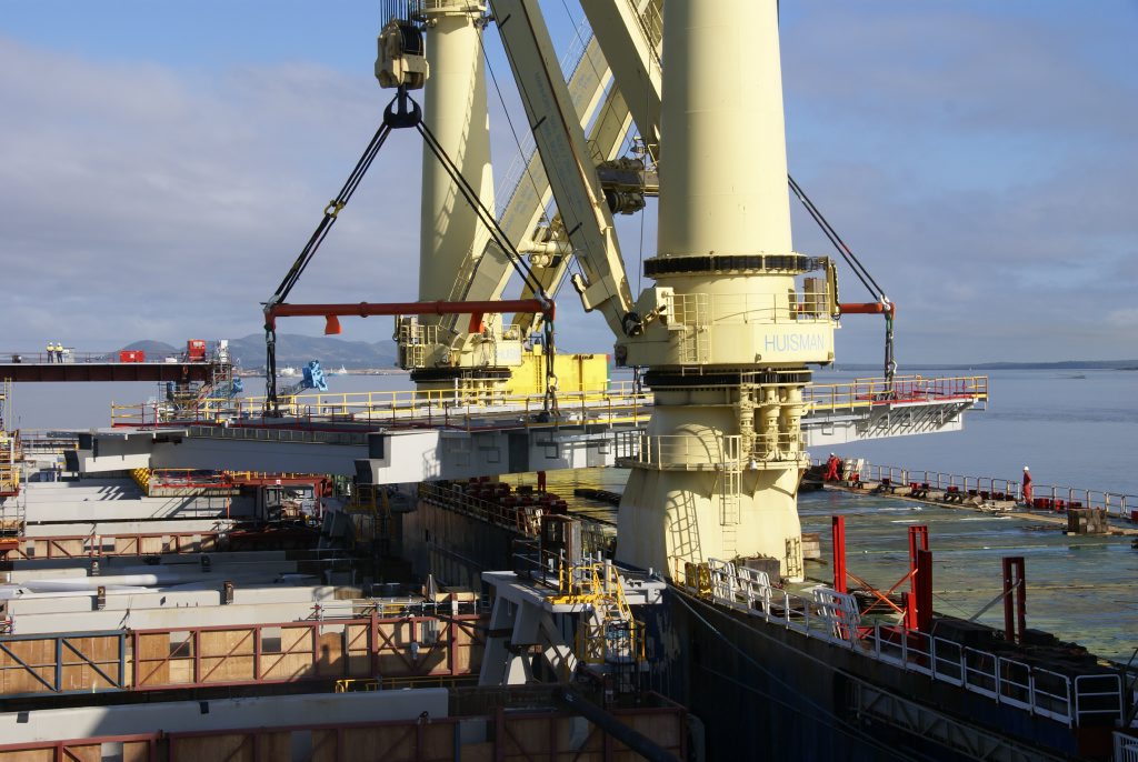 The first of the deck units required for the Wiggins Island Coal Export Terminal's wharf is lifted into place in September. The first of the deck units required for the Wiggins Island Coal Export Terminal's wharf is lifted into place in September.