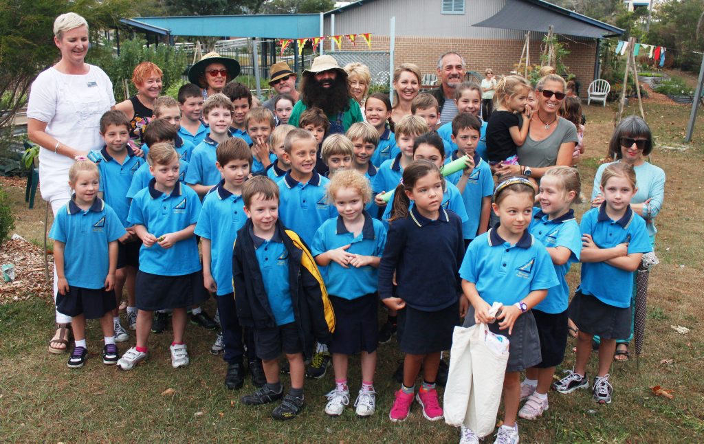 Gardening Australia's Costa Georgiadis in Bogangar Public School's community garden with students, teachers and community members.