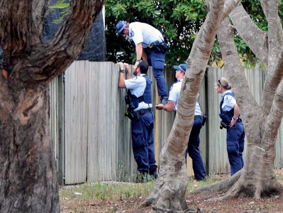 Police searching backyards in Kawungan. Police searching backyards in Kawungan.