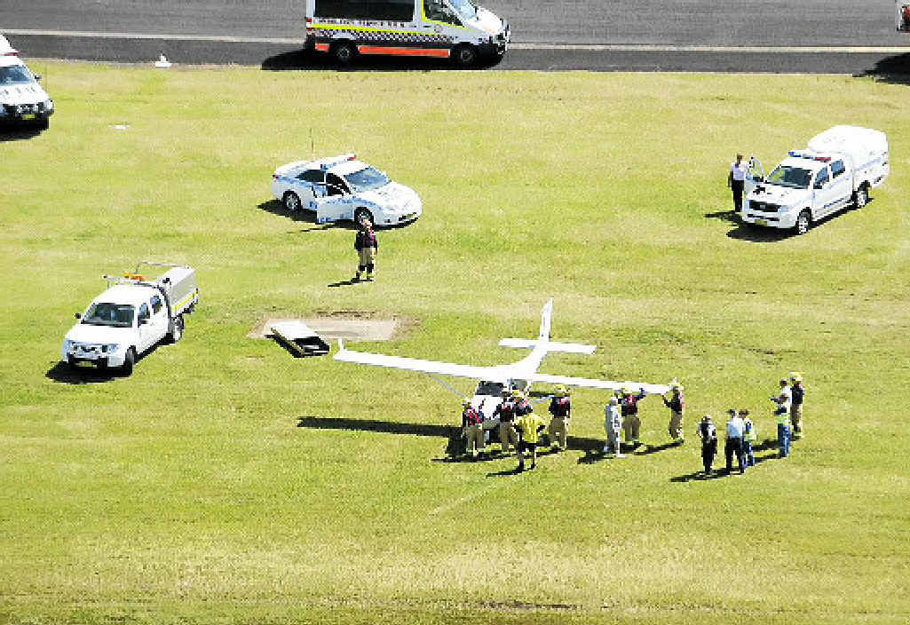 LUCKY ESCAPE: Emergency services attend the scene of a light aircraft mishap on the main runway at Ballina Airport yesterday morning. LUCKY ESCAPE: Emergency services attend the scene of a light aircraft mishap on the main runway at Ballina Airport yesterday morning.