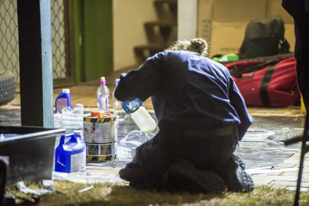 A Senior Constable inspects items found in a Carter Street residence as part of the two drug raids conducted in Gladstone. A Senior Constable inspects items found in a Carter Street residence as part of the two drug raids conducted in Gladstone.