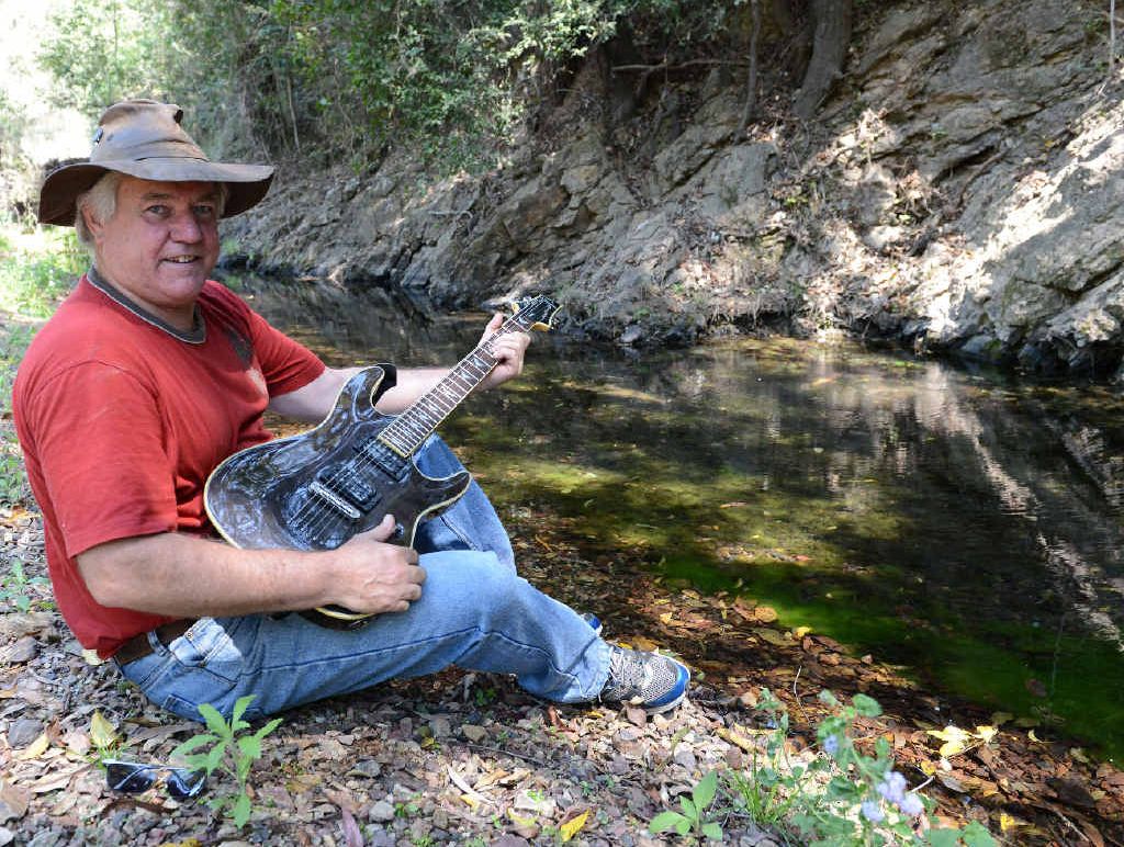 Jimmy Budgen on the banks of Mitchell Creek yesterday. The creek runs through the property where the Mitchell Creek Rock and Blues Festival starts this morning. Jimmy Budgen on the banks of Mitchell Creek yesterday. The creek runs through the property where the Mitchell Creek Rock and Blues Festival starts this morning.