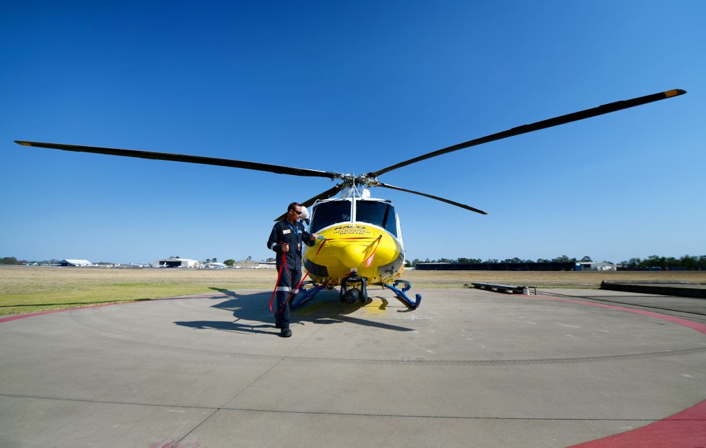 A crewman prepares the Bell 412 EP helicopter run by RACQ Capricorn Helicopter Rescue for flight. Photo: Chris Ison / The Morning Bulletin A crewman prepares the Bell 412 EP helicopter run by RACQ Capricorn Helicopter Rescue for flight. Photo: Chris Ison / The Morning Bulletin