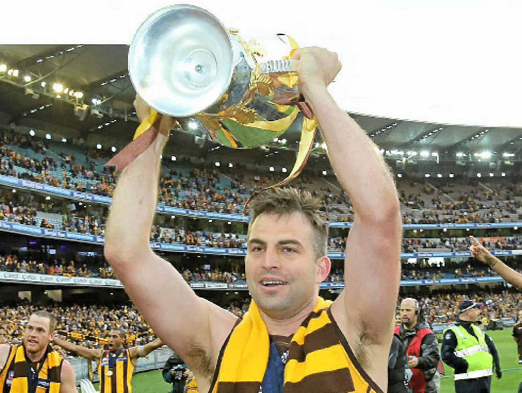 LIFE OF BRIAN: Hawthorn’s Brian Lake holds aloft the premiership cup. LIFE OF BRIAN: Hawthorn’s Brian Lake holds aloft the premiership cup.