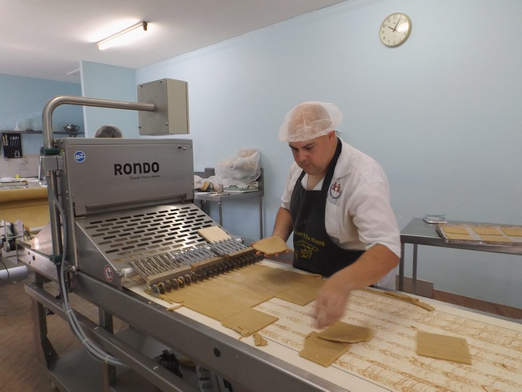Before the introduction of this $100,000 machine three years ago, HACCP officer Brendan Cole would cut the gingerbread dough by hand. The machine is cutting the walls to the Aussie Beach Shack. Before the introduction of this $100,000 machine three years ago, HACCP officer Brendan Cole would cut the gingerbread dough by hand. The machine is cutting the walls to the Aussie Beach Shack.