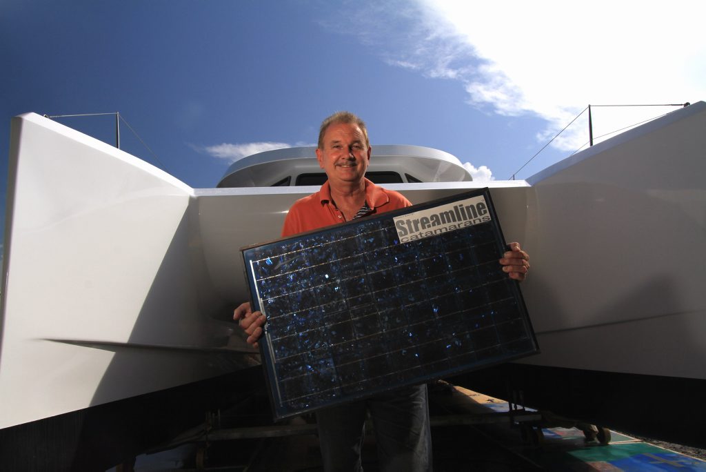 Project manager Wayne Jones with the first solar powered boat manufactured by hand in Hervey Bay. Project manager Wayne Jones with the first solar powered boat manufactured by hand in Hervey Bay.